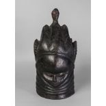 A Mende tribal hardwood mask, Sierre Leone, carved with stylised hair,