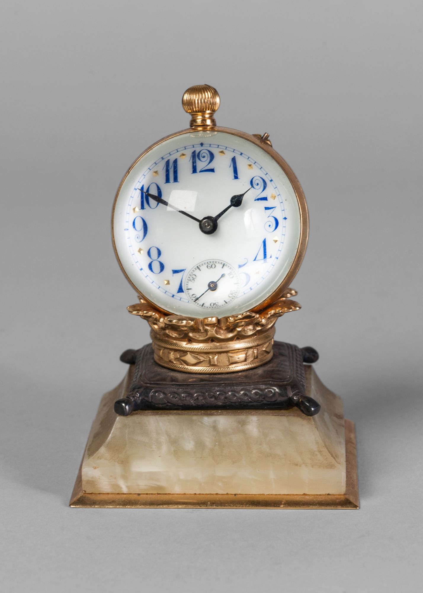 A French desk clock, late 19th century, in the form of a globe resting on a crown with a cushion,