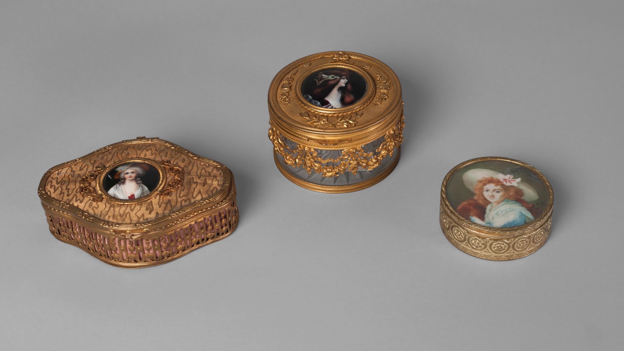 A French circular gilt metal box inset with a portrait miniature of a girl with red hair and a wide