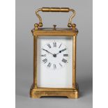 A French gilt brass carriage clock, 20th century, with a loop handle,