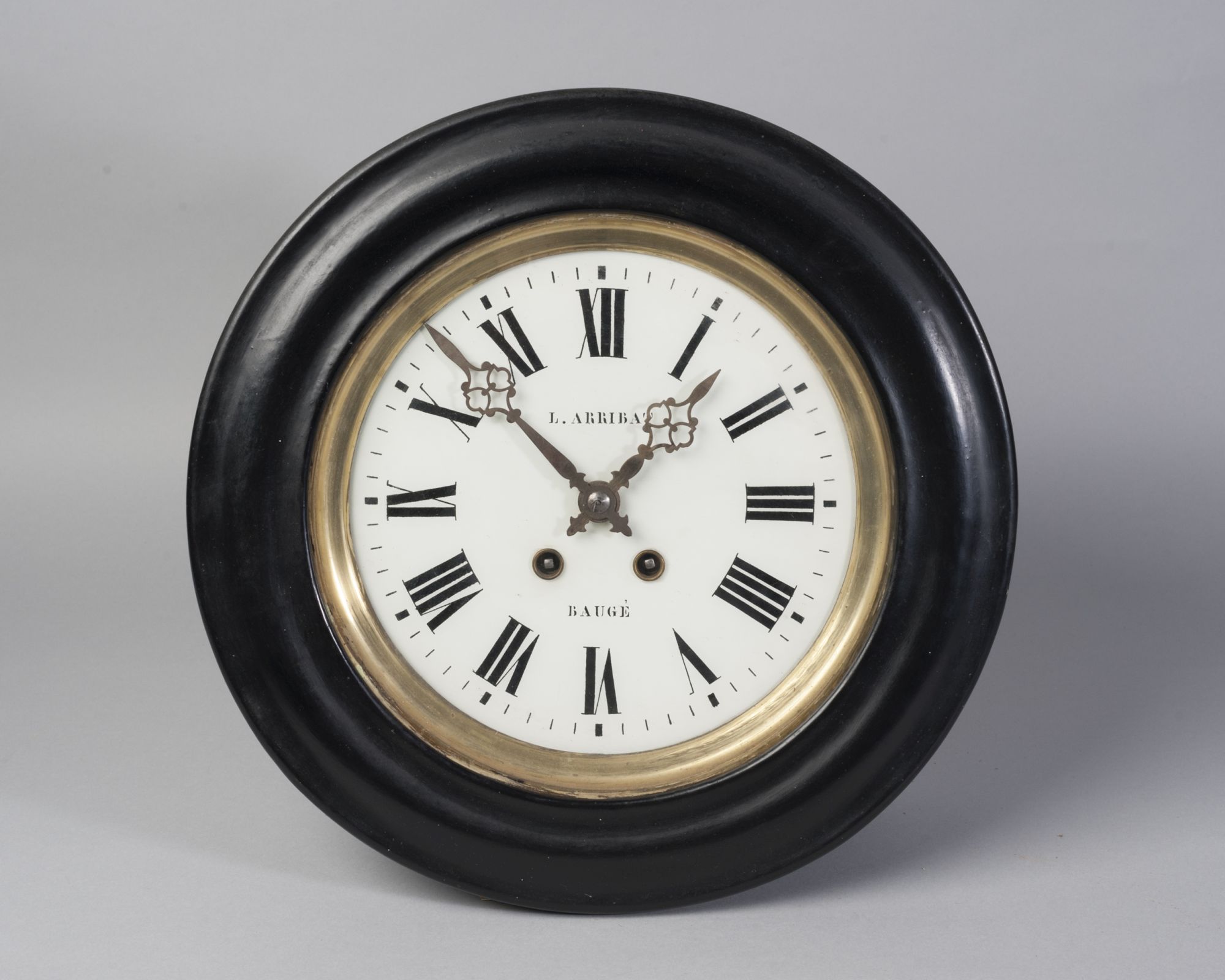 A French circular wall clock, late 19th century, with an ebonised case,