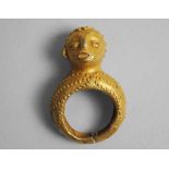 An African tribal gold ring, Ivory Coast, early/mid 20th century, mounted with a male head, 4.