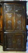 A 19th century carved oak corner cupboard