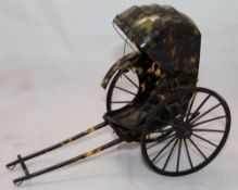 A late 19th/early 20th century model of a rickshaw,