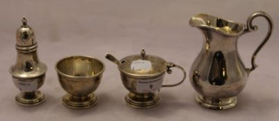 A silver condiment set and a plated jug