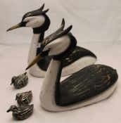 A family of painted carved wooden grebe decoys