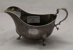 A large silver sauce boat