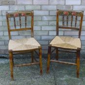 A pair of 19th century painted rush seated faux bamboo chairs