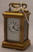 A gilt miniature carriage clock