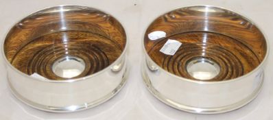 A pair of silver plated coasters