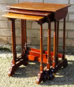 An Edwardian nest of three mahogany tables