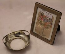 A silver photograph frame and a small silver and glass basket