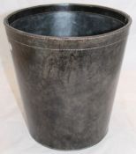 A round leather waste paper bin