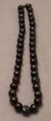 A string of black pearls with a 14 ct gold clasp