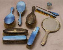 A quantity of silver and enamel dressing table brushes and mirrors