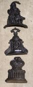 Three Victorian cast iron door stops