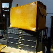 A small set of drawers and a pigskin case