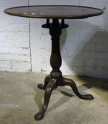 A mahogany tilt top tripod table