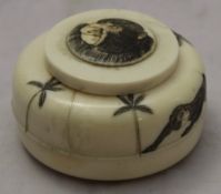 An early 20th century Japanese ivory inkwell decorated with monkeys