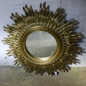 A golden sunburst mirror