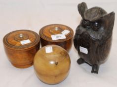 A carved wooden model of an owl and three treen pots