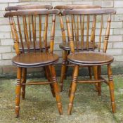 A set of four stick back kitchen chairs