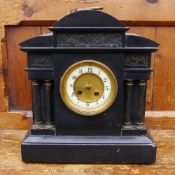 A Victorian black slate mantle clock
