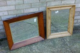 An oak framed mirror and another