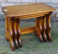 A blonde Ercol nest of three tables