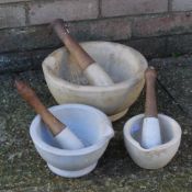 A large pestle and mortar and two others