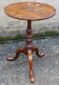 A 19th century elm tilt top tripod table