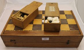 A Victorian inlaid games box and two chess sets
