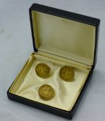 A pair of cufflinks in the form of coins