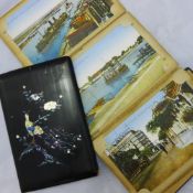 A mother-of-pearl inlaid postcard album