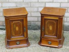 A pair of Edwardian inlaid mahogany cabinets