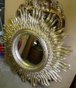 A gold painted star bust mirror