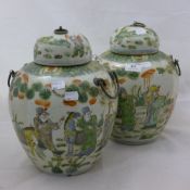 A pair of green and orange ginger jars