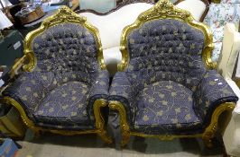 A pair of large gilt framed upholstered armchairs
