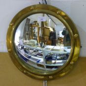 A brass port hole mirror