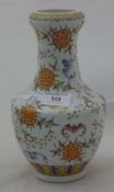 A small peach and bat decorated porcelain vase