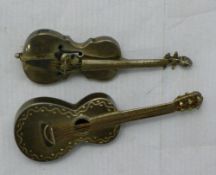 Two silver guitar/violin brooches