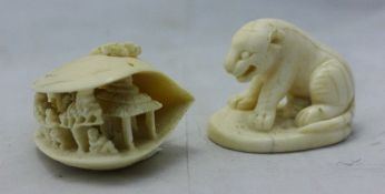 An ivory model of a tiger and an ivory clamshell