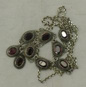 A silver and garnet necklace