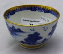 A small blue and gold rim tea cup