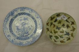 A Chinese porcelain bowl decorated with butterflies and a blue and white plate