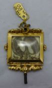 A gold framed hair inset panel