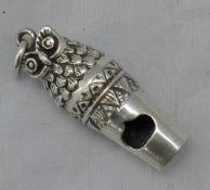 A silver whistle in the form of an owl