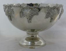 A large silver plated punch bowl decorated with grapes