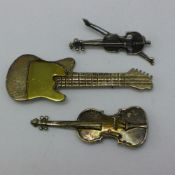 Three silver guitar brooches