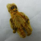 A miniature Schuco plush covered monkey